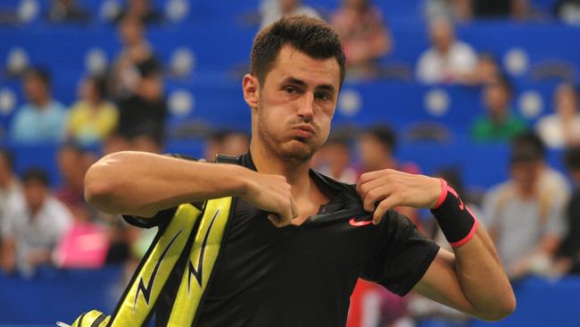 Bernard Tomic of Australia prepares to leave the court after he lost to Kyle Edmund of Britain during their men's singles first round match at the ATP Chengdu Open tennis tournament in Chengdu, China's southwestern Sichuan province on September 26, 2017. / AFP PHOTO / STR / China OUT