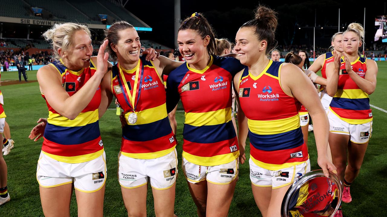 ADELAIDE, AUSTRALIA - SEPTEMBER 30: Marijana Rajcic, Chelsea Randall, Anne Hatchard and Ebony Marinoff of the Crows celebrate their win during the 2022 S7 AFLW Round 06 match between the Adelaide Crows and the Port Adelaide Power at Adelaide Oval on September 30, 2022 in Adelaide, Australia. (Photo by James Elsby/AFL Photos via Getty Images)