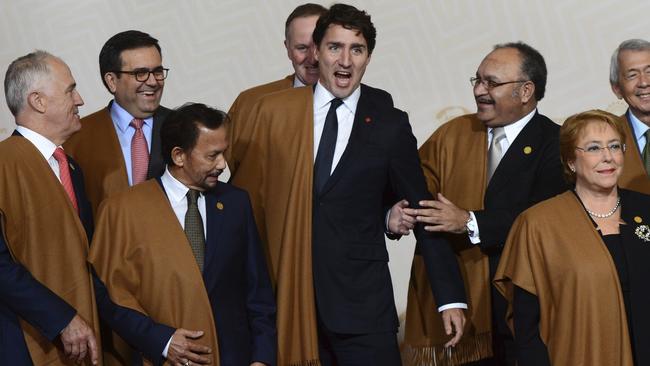 Canada's Prime Minister Justin Trudeau jokes around with fellow leaders during the group photo at the annual Asia Pacific Economic Cooperation, APEC, summit in Lima, Peru, Sunday, Nov. 20, 2016. The APEC forum closed with a joint pledge to work toward a sweeping new free trade agreement that would include all 21 members as a path "sustainable, balanced and inclusive growth," despite the political climate. (Sean Kilpatrick /The Canadian Press via AP)