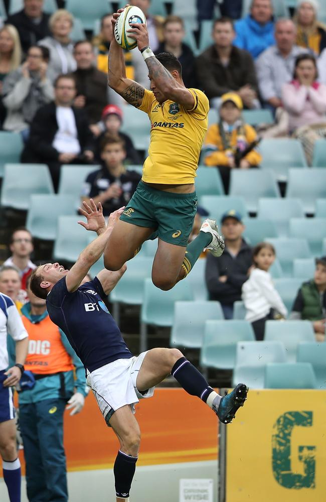 Israel Folau launches himself to claim a Bernard Foley cross-kick and score for the Wallabies against Scotland last month.