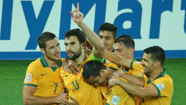 MELBOURNE, AUSTRALIA - JANUARY 09: Mile Jedinak of the Socceroos is congratulated by his teammates after scoring a goal during the 2015 Asian Cup match between the Australian Socceroos and Kuwait at AAMI Park on January 9, 2015 in Melbourne, Australia. (Photo by Scott Barbour/Getty Images)