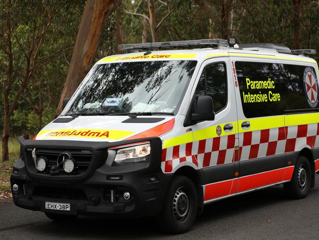 SYDNEY, AUSTRALIA - NewsWire Photos JANUARY 20, 2021: An ambulance passes by a police road block near Keith Longhurst Reserve near where a police search is underway on the Georges river for a 15-year-old teenage boy believed to have drowned while swimming.Picture: NCA NewsWire / Damian Shaw