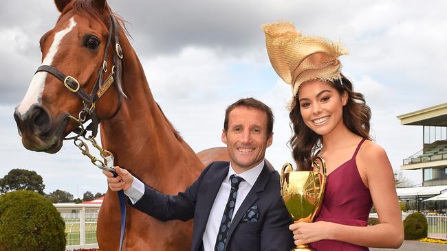 Jockey Damien Oliver with racehorse, Hero and Elissa from Vivien's Model Management with the Caulfield Cup at the Caulfield Race Track. Picture: Tony Gough