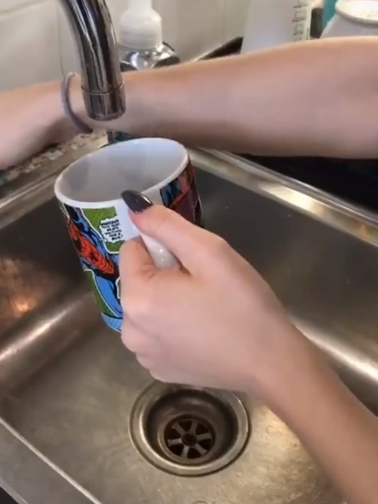 With the help of her daughter to demonstrate, the mum begins with asking viewers to add water to a mug. Picture: Twitter