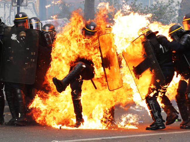 French CRS anti-riot police officers are engulfed in flames as they face protesters during a march for the annual May Day workers' rally in Paris on May 1, 2017. Picture: AFP PHOTO / Zakaria ABDELKAFI