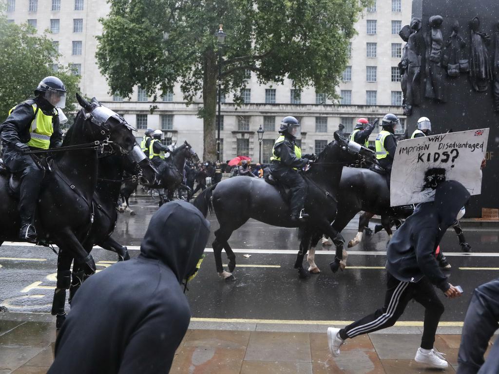 Mounted police charged demonstrators to push them back. Picture: Frank Augstein/AP