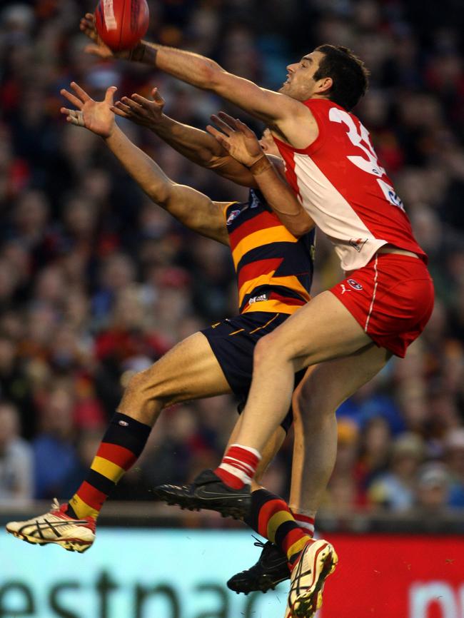 Marty Mattner in action for the Swans against Current Crows captain Taylor Walker.