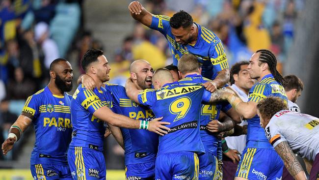 The Eels celebrate during their epic victory on Friday night.