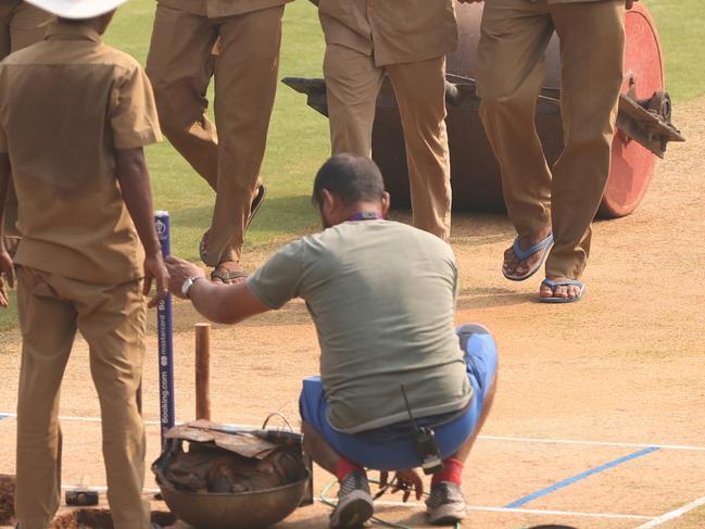 MUMBAI, INDIA - NOVEMBER 14: Grounds keepers prepare the pitch during a New Zealand training session at the ICC Men's Cricket World Cup India 2023 at Wankhede Stadium on November 14, 2023 in Mumbai, India. (Photo by Robert Cianflone/Getty Images)