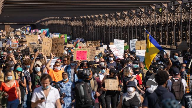 Hundreds of protesters march across the Brooklyn Bridge at a rally calling for police reform.