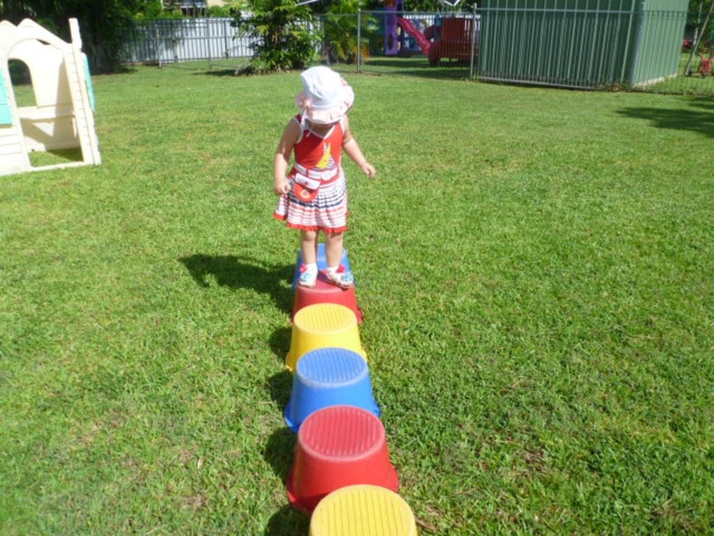 A child carefully treads colour stools in the play area at the Casuarina Childcare Centre. Picture: Supplied.