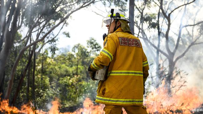 Nicholas Raphael burning around properties in Canoelands today. Picture: Darren Leigh Roberts