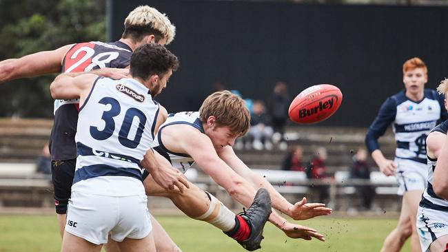 Andre Parrella tries to kick away under pressure from South's Cameron McGree at Richmond Oval. Picture: MATT LOXTON