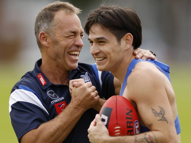 MELBOURNE, AUSTRALIA - MARCH 28: Alastair Clarkson, Senior Coach of the Kangaroos share a laugh with Zac Fisher of the Kangaroos during a North Melbourne Kangaroos AFL training session at Arden Street Ground on March 28, 2024 in Melbourne, Australia. (Photo by Darrian Traynor/Getty Images)