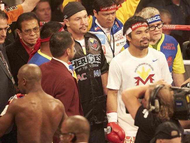 Fortune (black hat) with Pacquiao and trainer Freddie Roach (blue headband), ahead of Pacman’s blockbuster with Floyd Mayweather. Picture: Simon Bruty /Sports Illustrated via Getty Images