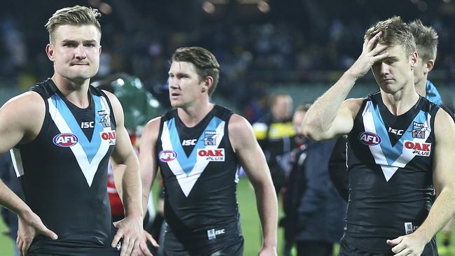 The pain shows for Port Adelaide’s Ollie Wines, Matt White and Robbie Gray after the Power’s loss to Richmond. Better goalkicking could have led to a very different result. Picture: Sarah Reed