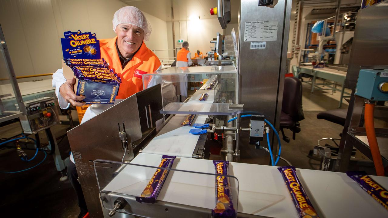 Phil Sims with Violet Crumble bars in the Glynde factory in South Australia in 2018, soon after his company bought the brand.