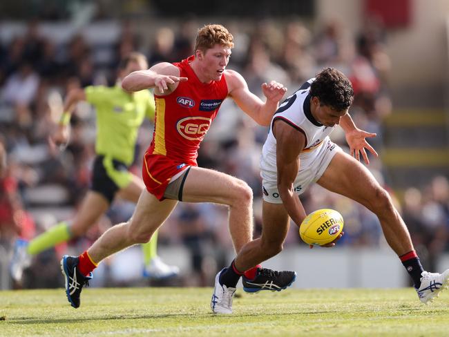 Ben Davis of the Crows evades Matthew Rowell of the Suns during the 2020 Marsh Community Series match between the Adelaide Crows and the Gold Coast Suns at Flinders University Stadium on March 06, 2020 in Adelaide, Australia. (Photo by AFL Photos)