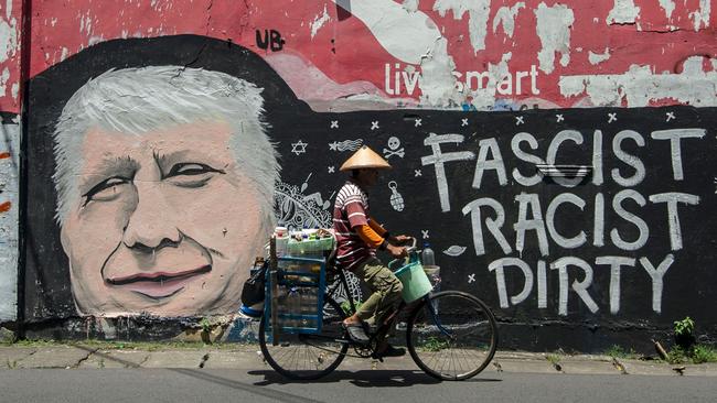 As the world watches, graffiti like this can be seen as far afield as east Java in Indonesia. Picture: Juni Kriswanto/AFP