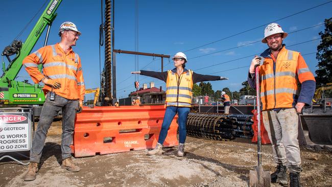 Senior Safety officer Michelle Adams checks distancing with workers Simon Bray and Mick Lonie at a level crossing construction site in Cheltenham. Picture: Jake Nowakowski