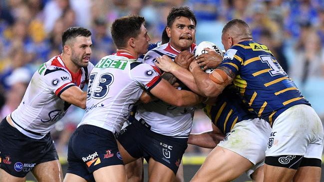 Latrell Mitchell of the Roosters (C) is a hold. Picture: AAP Image/Dan Himbrechts