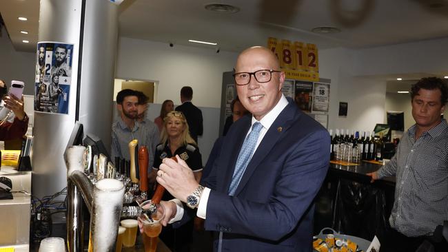 Peter Dutton pouring a beer as he visited Townsville RSL during 2025 ANZAC Day in North Queensland.Picture: Richard Dobson / Newswire