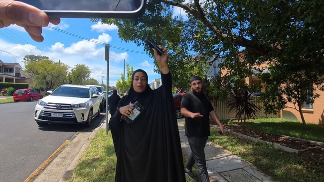 People outside the home of Sarah Abu Lebdeh, the female nurse accused of threatening to kill Israeli patients at Bankstown Hospital.