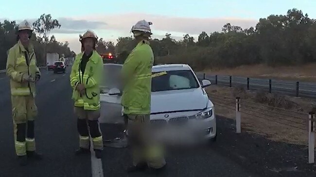 Firefighters beside the crashed BMW on the M1 on Saturday.