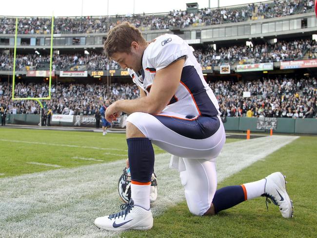 Tim Tebow was known for praying on the sidelines before games. (Photo by Ezra Shaw/Getty Images)