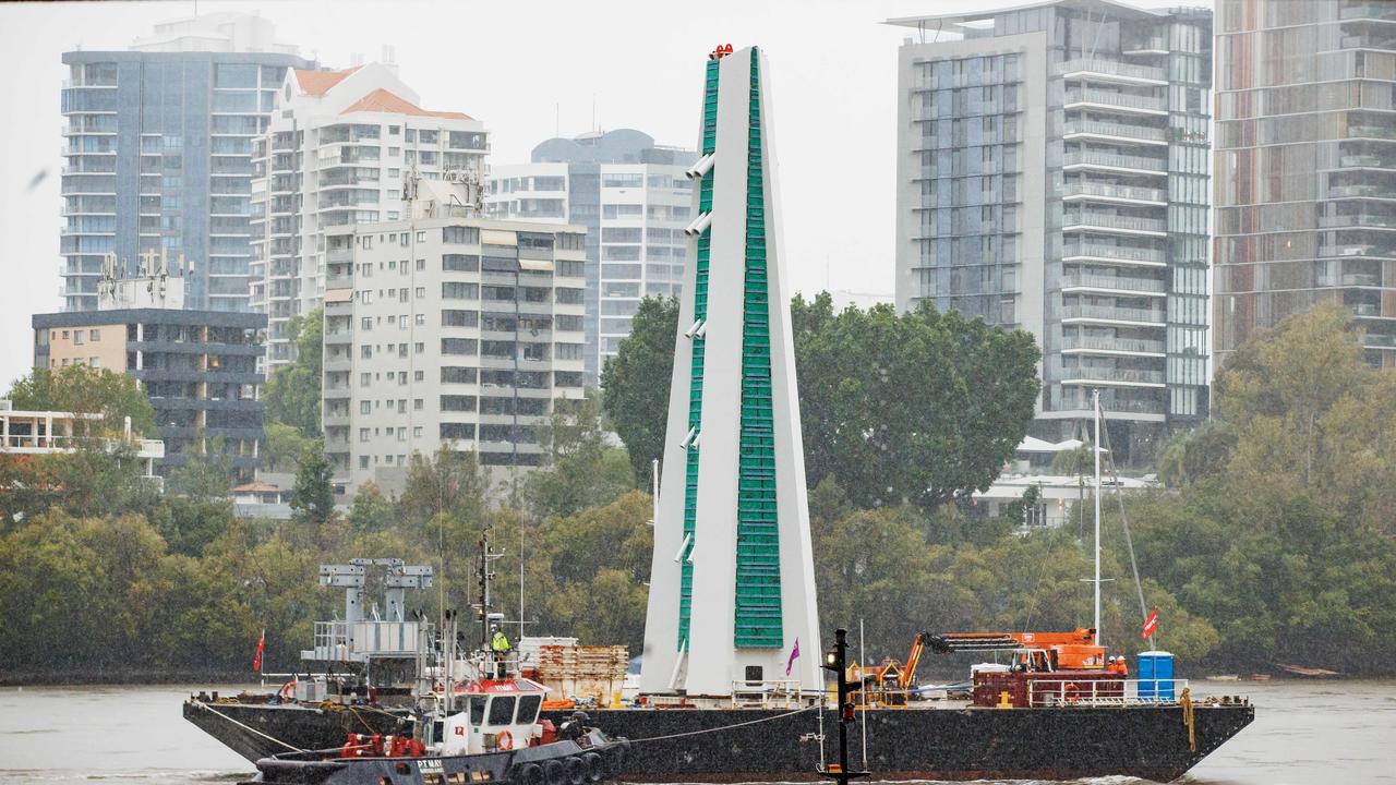 A piece of the under construction Kangaroo Point Green Bridge part is delivered by barge along the Brisbane River. Picture Lachie Millard