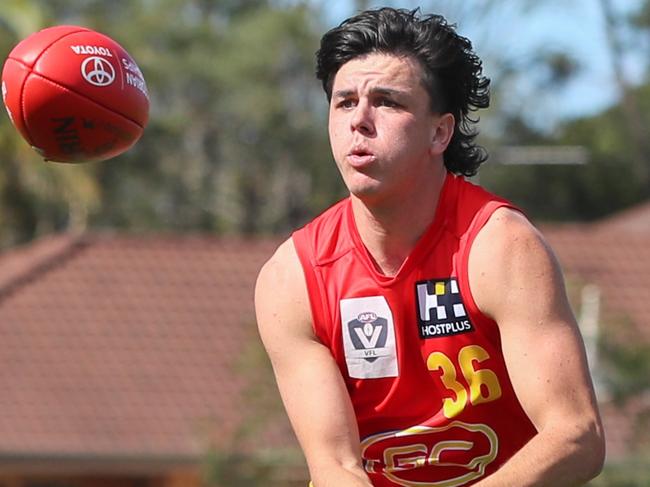 BRISBANE, AUSTRALIA - JULY 24: Elijah Hollands of the Suns handballs during the VFL Round 15 match between the Aspley Hornets and the Gold Coast Suns at Graham Road Oval on July 24, 2021 in Brisbane, Australia. (Photo by Russell Freeman/AFL Photos)