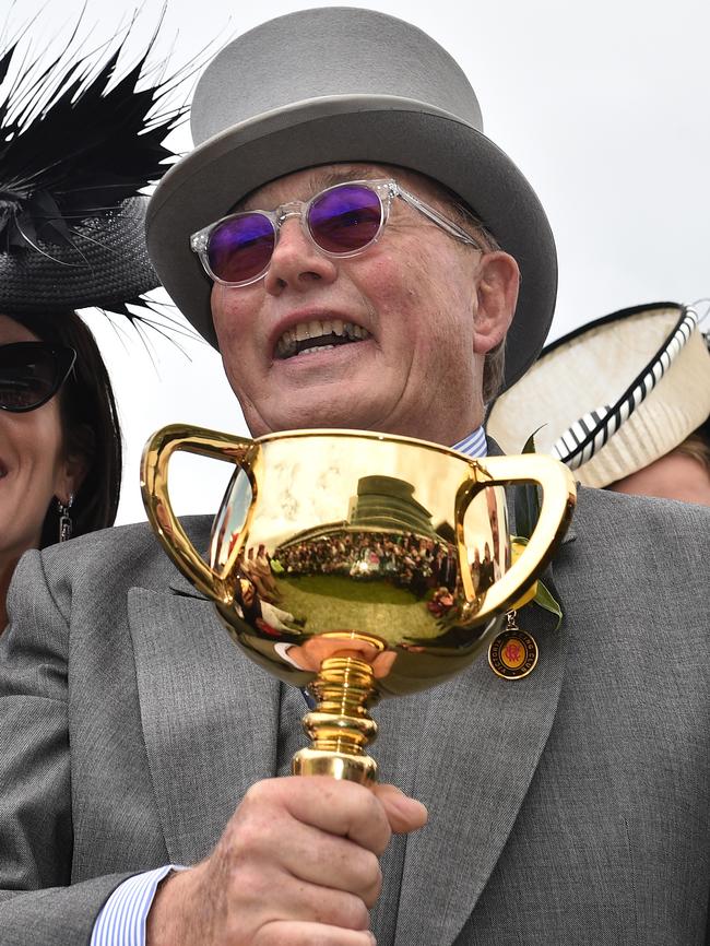 Lloyd Williams holds the Melbourne Cup.