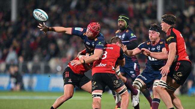 Reds forward Harry Wilson reaches for the ball during Queensland’s loss to the Crusaders. Picture: Kai Schwoerer/Getty Images