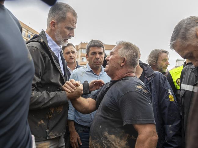 Spain's King Felipe VI speaks with people amid angry Spanish flood survivors in Paiporta. Picture: AP