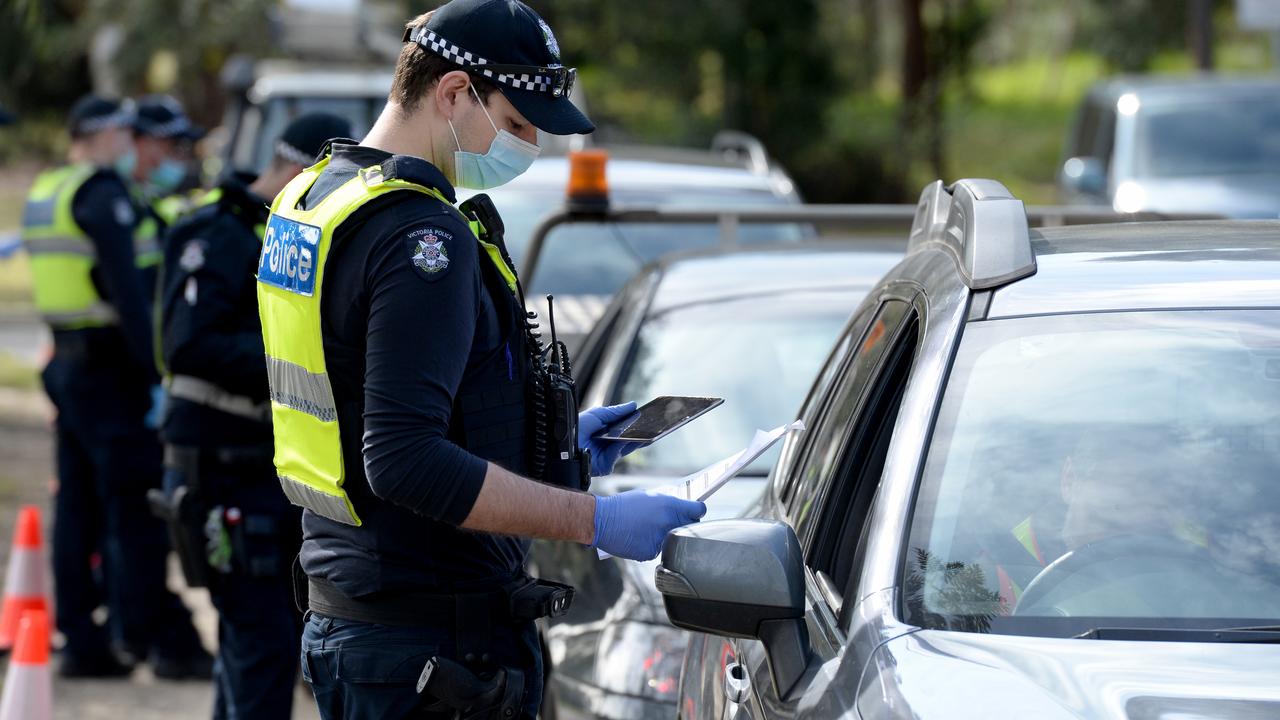 Police check travel permits at a mobile checkpoint at Eltham in Melbourne's outer northeast. Picture: NCA NewsWire/Andrew Henshaw