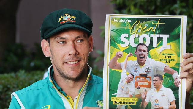 Scott Boland holding a copy of the Herald Sun after his stunning Test debut. Picture: David Crosling