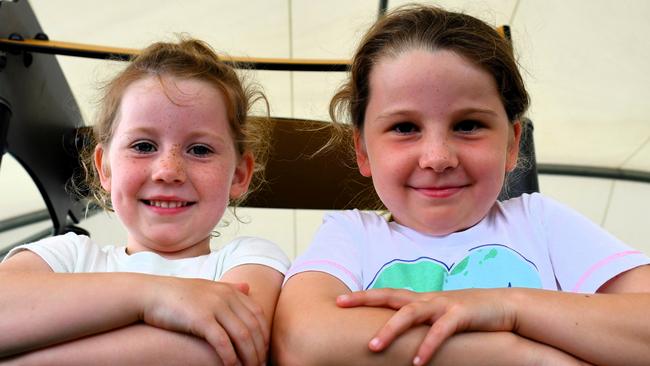 Edge Hill State School students Caitlin, 4, and Sierra, 7, from Cairns enjoying the facilities at the covered Rotary Park Playground in Ingham on Monday. Picture: Cameron Bates