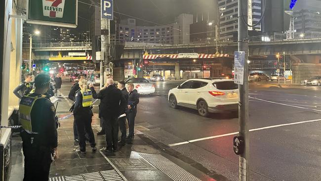 Police cordon off a footpath on Flinders St from Downie St through to Spencer St. Picture: Edward Bourke