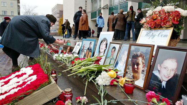 A woman puts a portrait of her relative in front of the Dubrovka Theatre in Moscow, where Chechen commandos took hundreds hostages during the Nord-Ost musical in October 2002. Picture: AFP