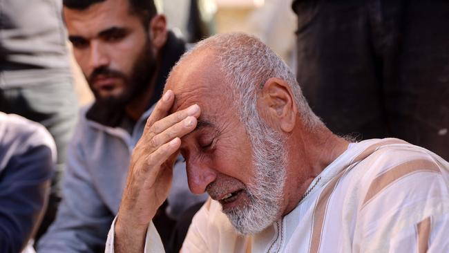 A mourner reacts to bodies of victims being removed after being killed by Israeli bombardment in Beit Lahia in the northern Gaza Strip.