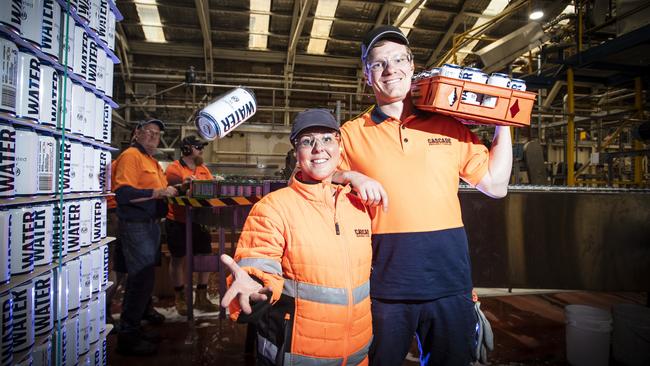 Cascade Brewery’s Anita Holdsworth and Zander Evershed-Brown in the canning section of the factory that is producing water cans to donate to communities around Australia affected by natural disasters, including bushfires. Picture: LUKE BOWDEN