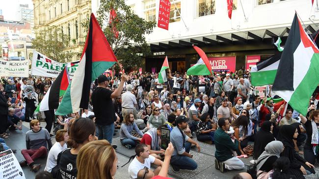 Pro Palestine marchers have a short sit in, in the Bourke St Mall. Picture: Lawrence Pinder