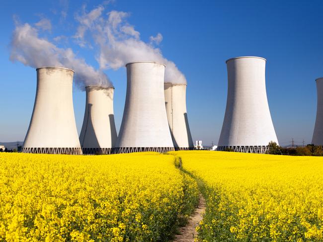 Panoramic view of Nuclear power plant Jaslovske, cooling tower, Bohunice with golden flowering field of rapeseed - Slovakia - two possibility for production of electric energy