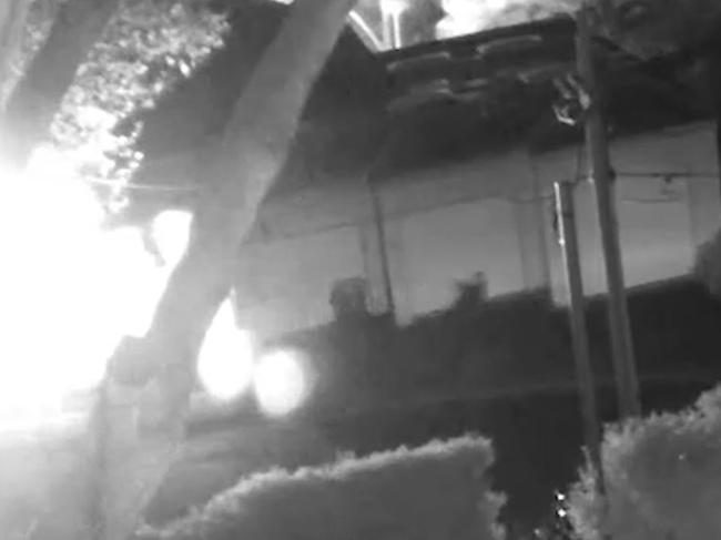 A person is seen running from the house as it goes up in flames. Picture: NSW Police