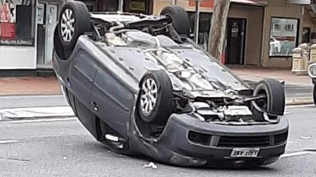 The car flipped on to its roof after it collided with a Nissan on Henley Beach Rd about 10am. Picture: Julie