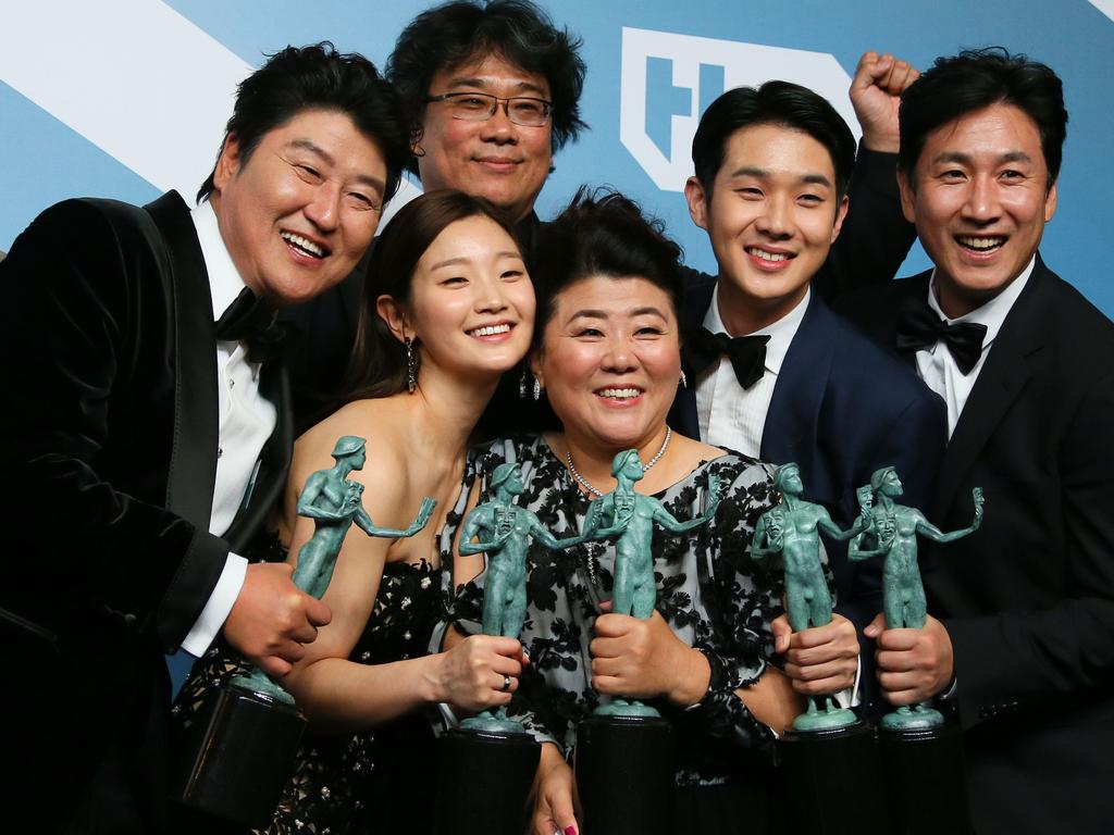 The Parasite cast (L-R) Song Kang-ho, Cho Yeo-jeong, director Bong Joon-ho, Lee Jung-eun, Choi Woo-shik, and Lee Sun-kyun pose with the trophy for Outstanding Performance by a Cast in a Motion Picture in the press room during the 26th Annual Screen Actors Guild Awards. Picture: AFP