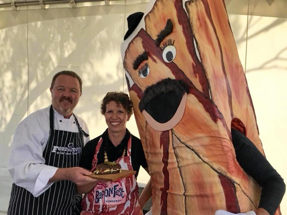 South Burnett chef Jason Ford shares his Rueben bacon sandwich with Kathryn Stevens and BaconMan ahead of Kingaroy's BaconFest. Picture: BaconFest