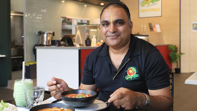Director and founder of Spicy Bite Daulat Singh Panwar with a butter chicken curry at the new Spicy Bite restaurant at Smithfield Shopping Centre. Picture: Brendan Radke