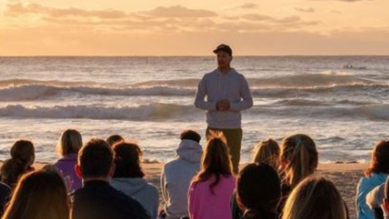 The angry man emerged from the ocean behind the group. Picture: Instagram/consciouscommunity___