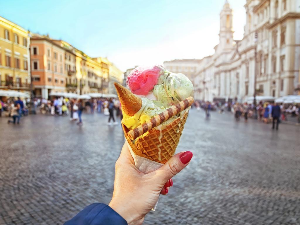 ESCAPE: How I travel, Celeste Mitchell -  Italian ice - cream cone held in hand on the background of Piazza Navona in Rome , Italy  Picture: Istock